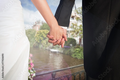 Cute young newlyweds holding their hands