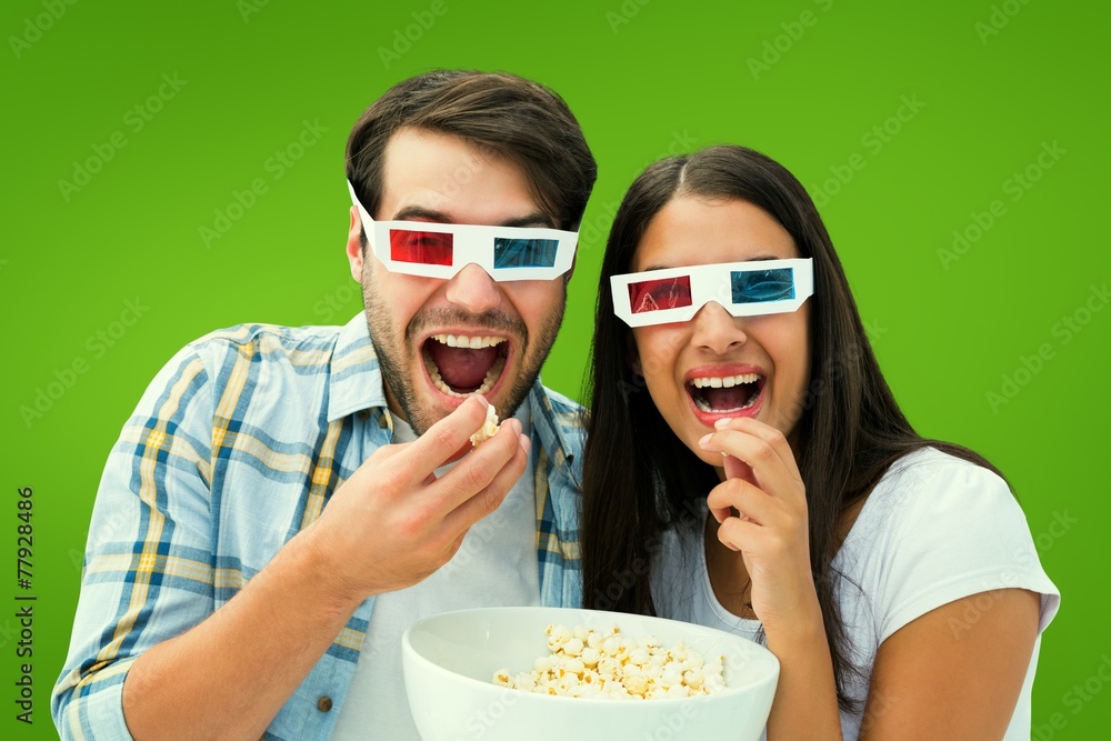 Obraz premium Composite image of attractive young couple watching a 3d movie