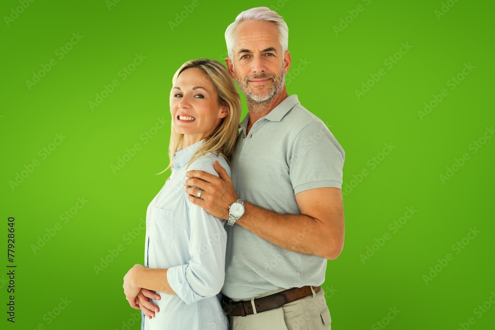 Composite image of happy couple smiling at camera Composite image of happy couple smiling at camera