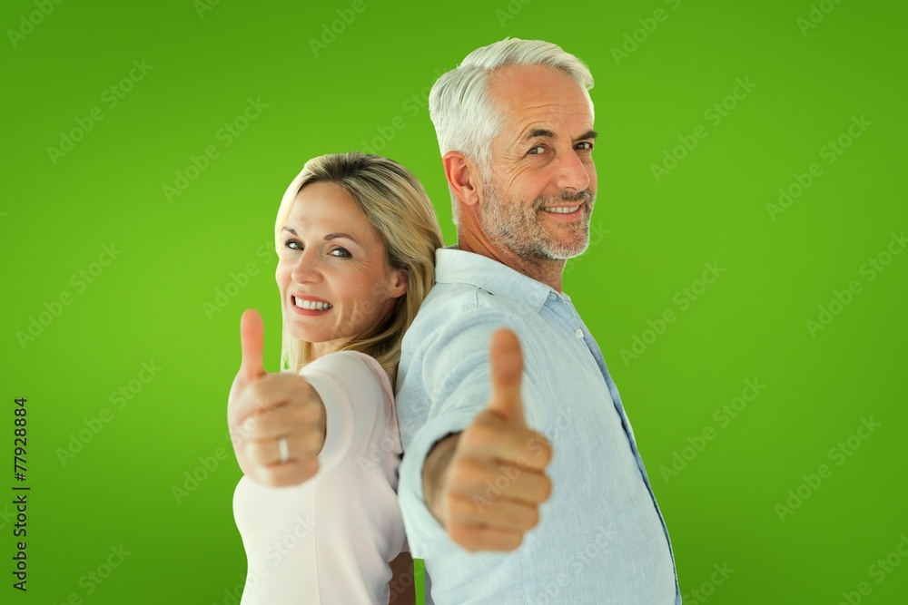 Composite image of smiling couple showing thumbs up together Composite image of smiling couple showing thumbs up together