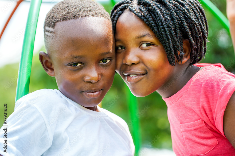 Young African brother and sister joining heads outdoors. Young African brother and sister joining heads outdoors.