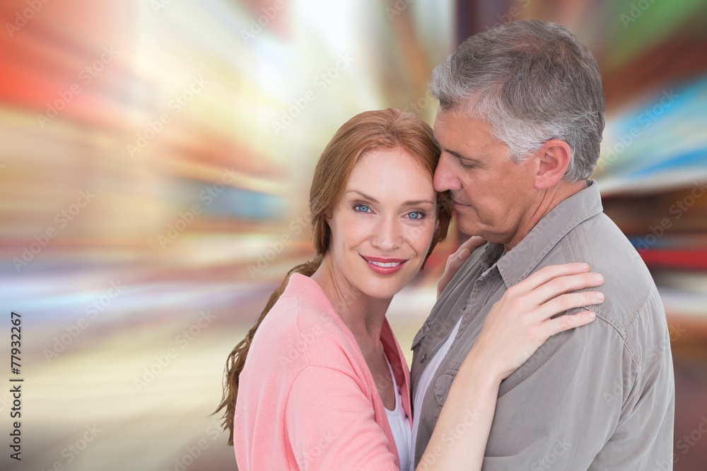 Composite image of casual couple hugging and smiling Composite image of casual couple hugging and smiling