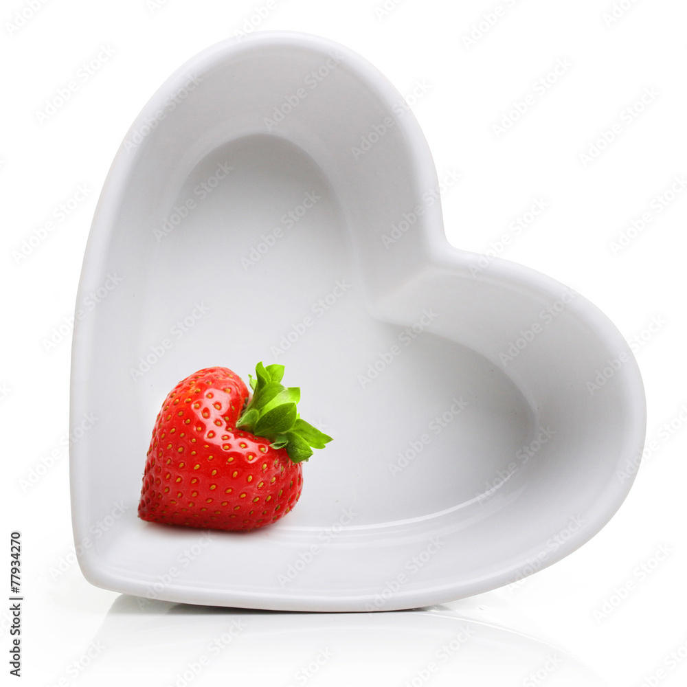 Red berry strawberry in heart shape plate - obrazy, fototapety, plakaty 
