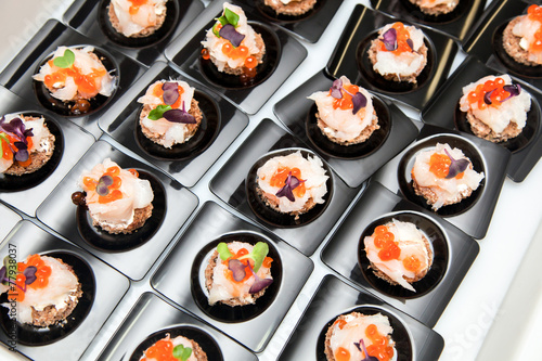 Salmon eggs, fish, and herbs canapes