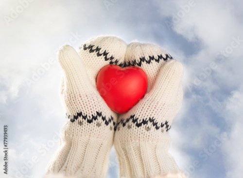 Close up of little girl hands holding red heart