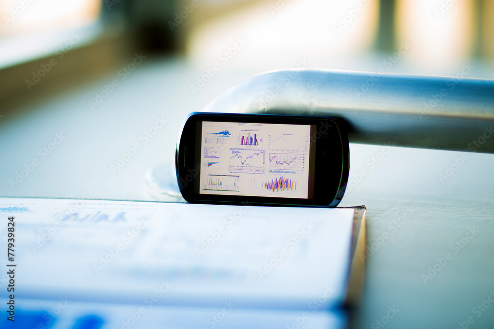 Business chart with smart phone and pen Business chart with smart phone and pen