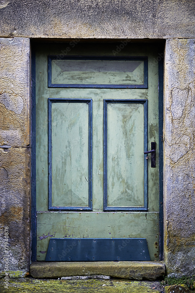 Old green door in a stone frame Old green door in a stone frame
