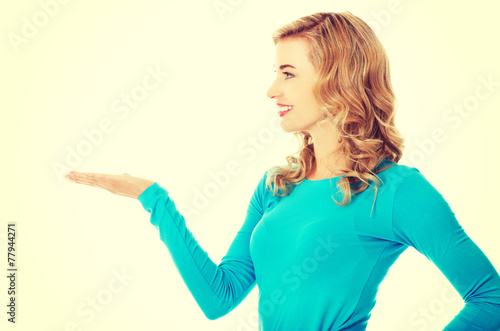 Woman showing something or copyspase