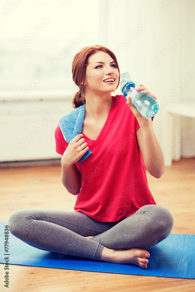smiling girl with bottle of water after exercising smiling girl with bottle of water after exercising