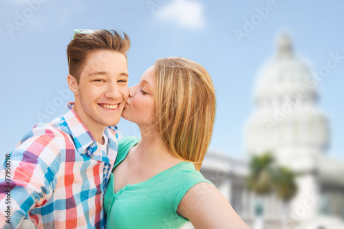 couple kissing and taking selfie over white house © Syda Productions