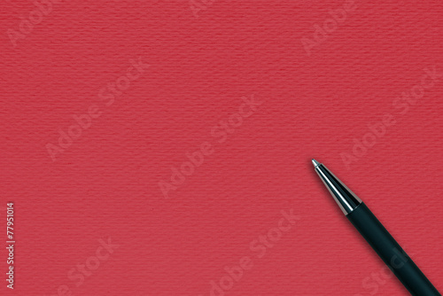 Black ball pen on the red papper background