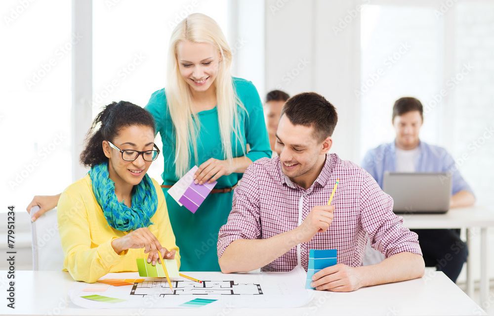 smiling interior designers working in office smiling interior designers working in office