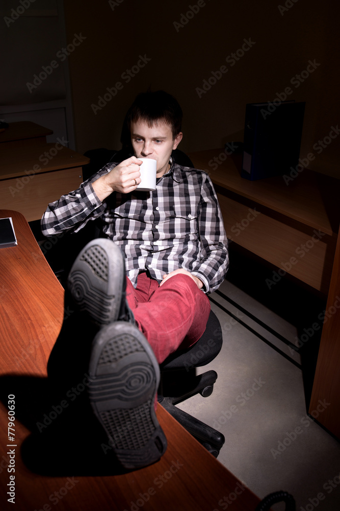 Worker sitting at a table and drinking tea