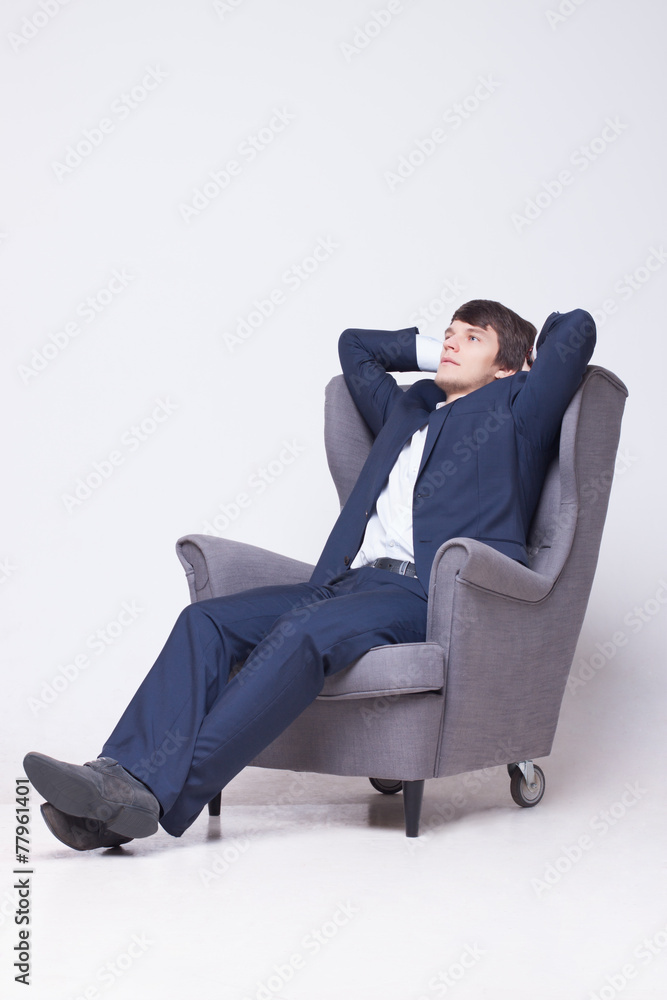 business man sits on chair over white background