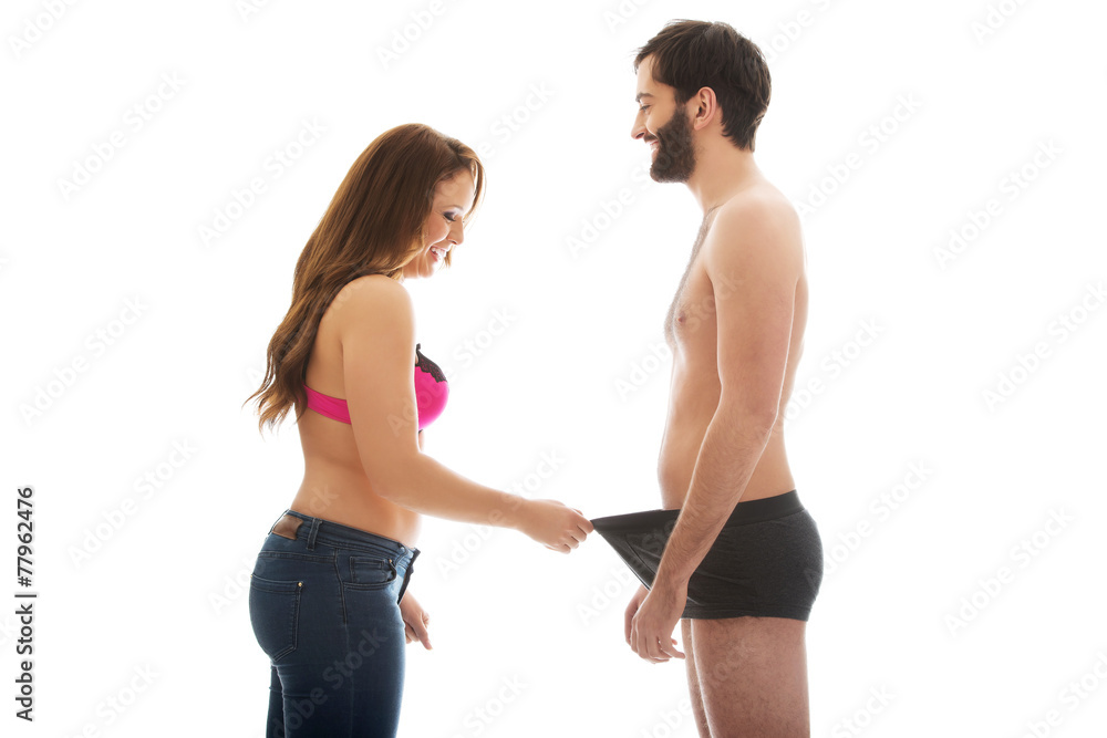 Attractive woman looking into man's panties. Stock Photo | Adobe Stock