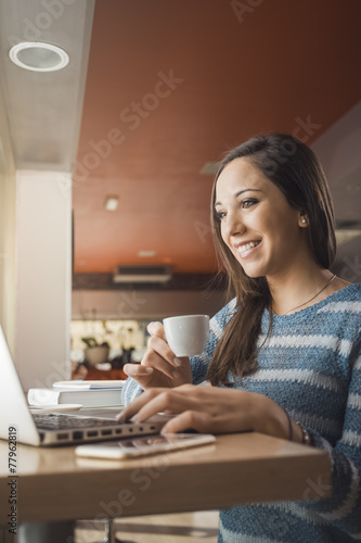 Woman at the bar using a laptop