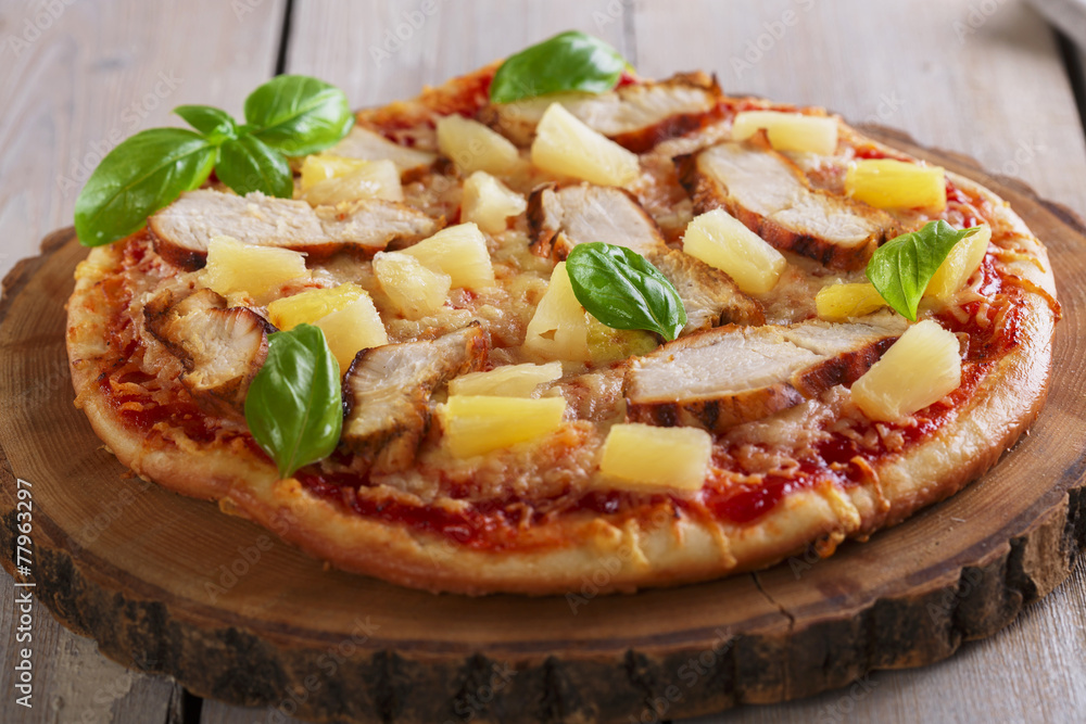 Pizza with cheese and pineapple chicken on board Pizza with cheese and pineapple chicken on board