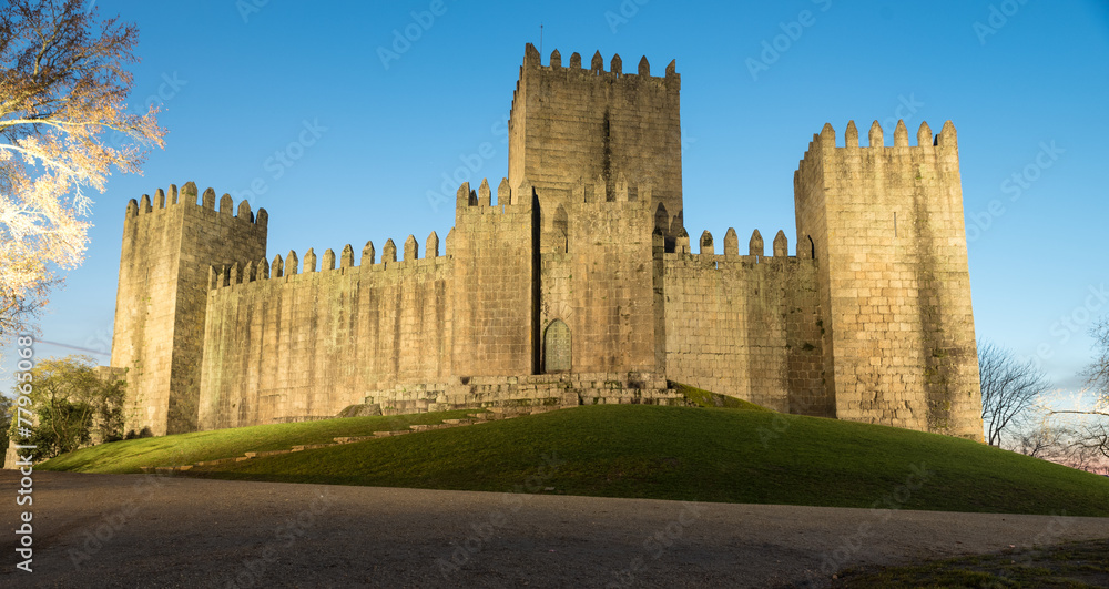 castle of guimaraes in portugal at night with lamps