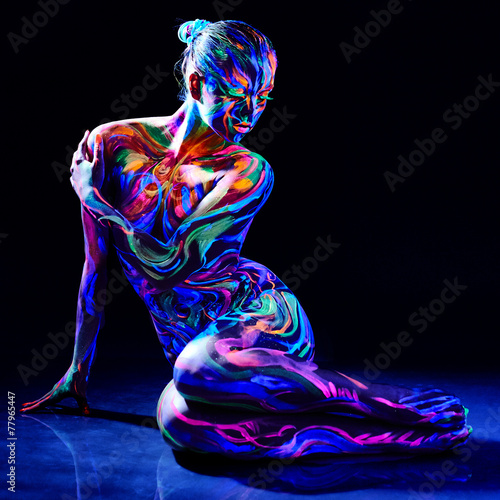 Charming nude girl with luminescent body art