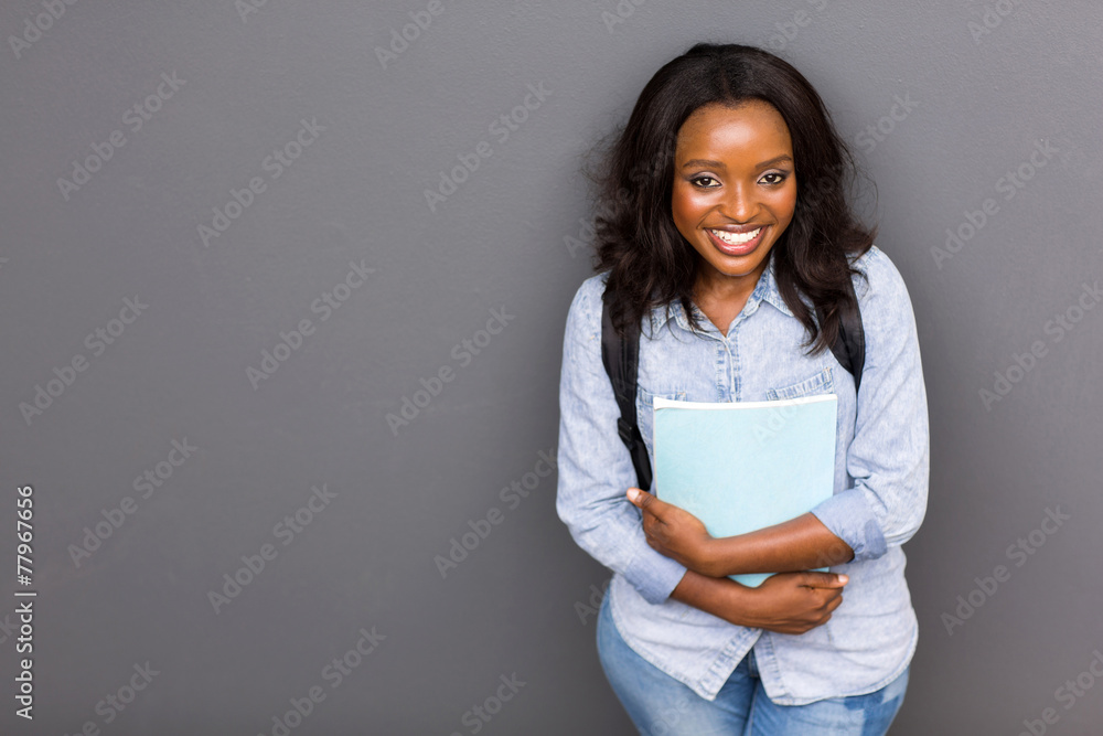 young african university girl standing against the wall young african university girl standing against the wall