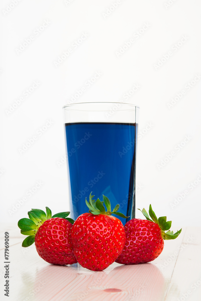 Glass with cold blue Thai tea and strawberries Glass with cold blue Thai tea and strawberries