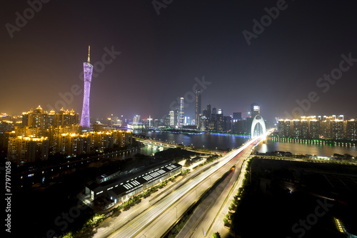 traffic blur motion on bridge with night cityscape background