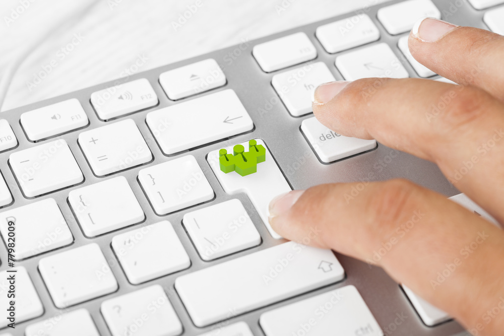 Woman pushing teamwork key on keyboard Woman pushing teamwork key on keyboard