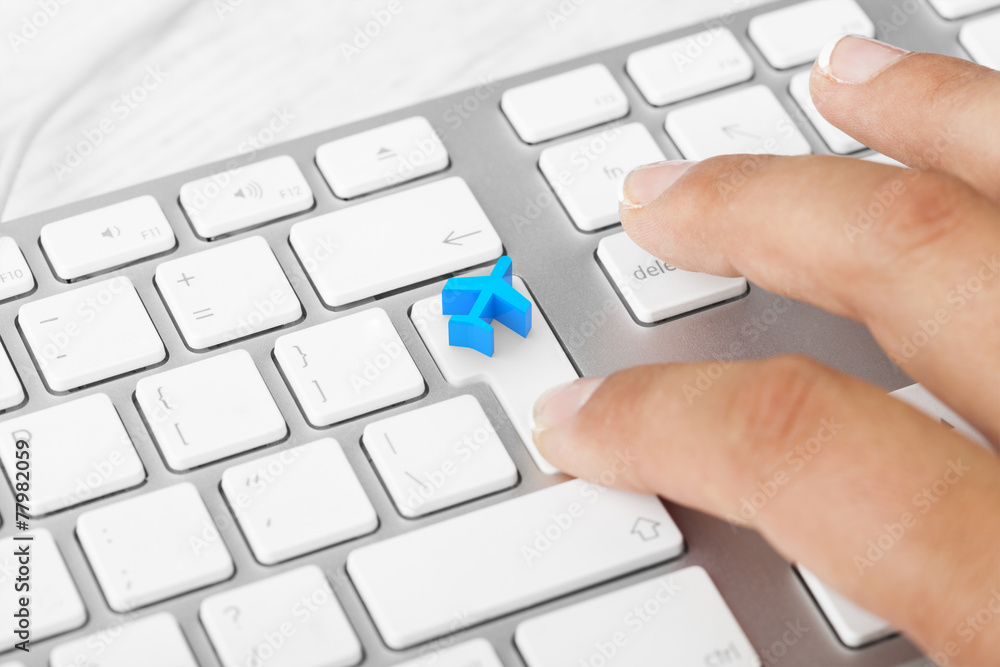 Woman pressing Travel Key On Computer Keyboard Woman pressing Travel Key On Computer Keyboard