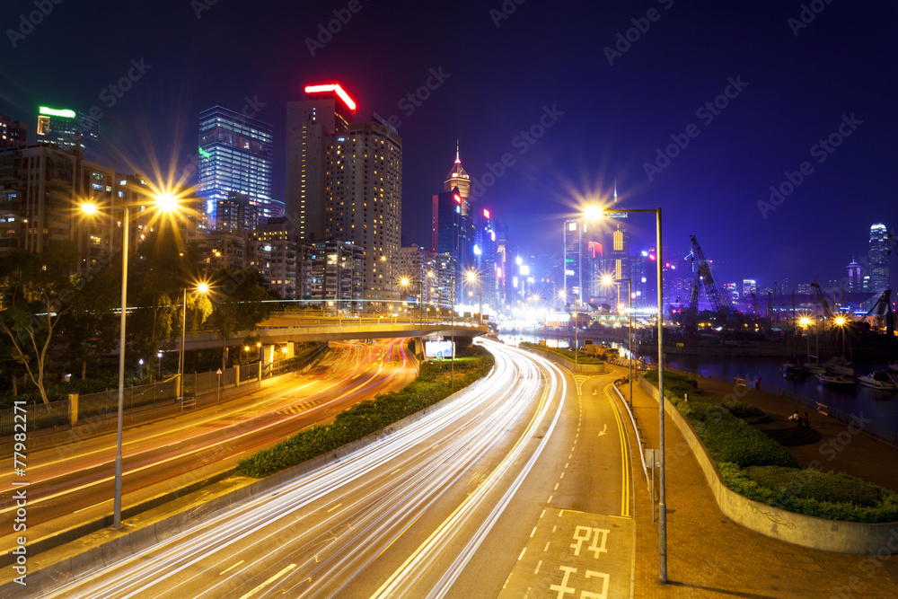 Traffic blur motion trails in modern city street at night
