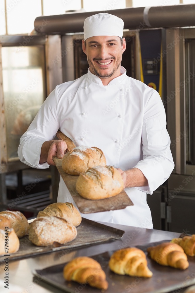 Happy baker showing tray of fresh bread Happy baker showing tray of fresh bread