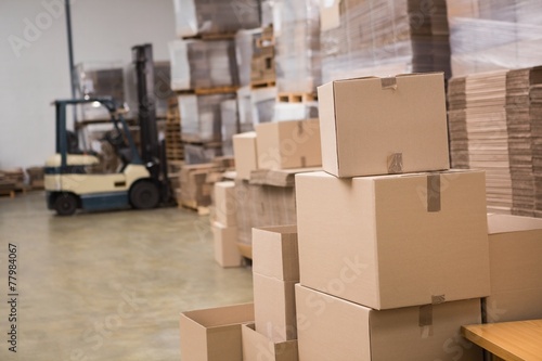 Schilderij op canvas Forklift in a large warehouse