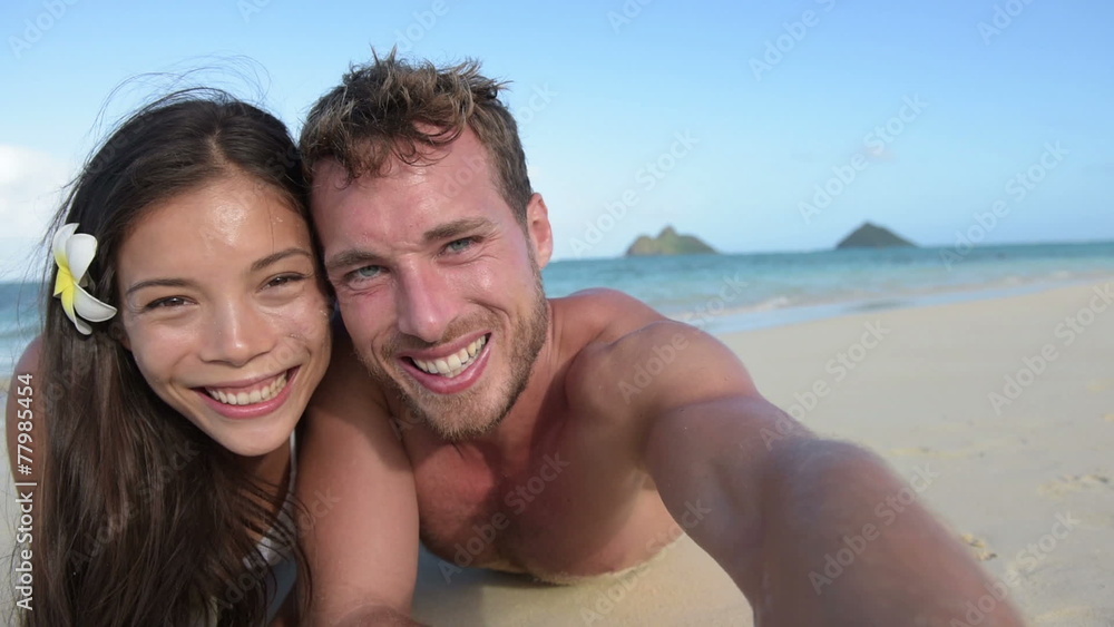 Couple relaxing on beach taking selfie picture Couple relaxing on beach taking selfie picture