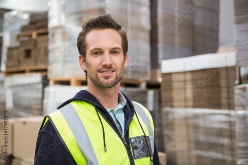 Warehouse worker smiling at camera