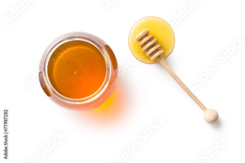 Fotografia honey dipper and honey in jar
