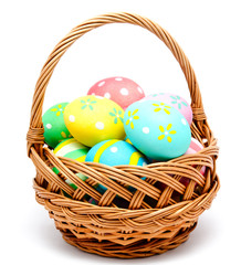 Colorful handmade easter eggs in the basket isolated