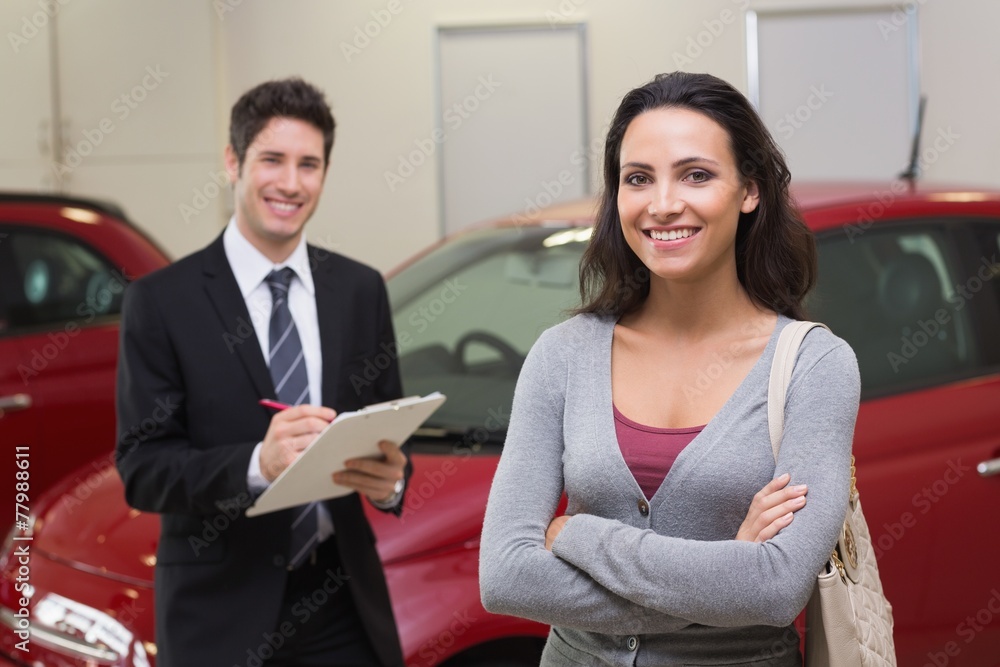 Smiling businessman undersign a car contract Smiling businessman undersign a car contract