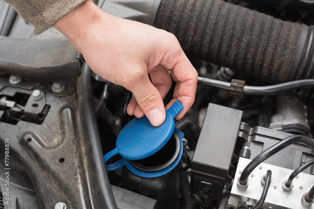 Man checking the engine of his car