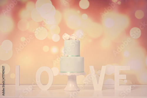 2tier green cake with LOVE letters in background photo