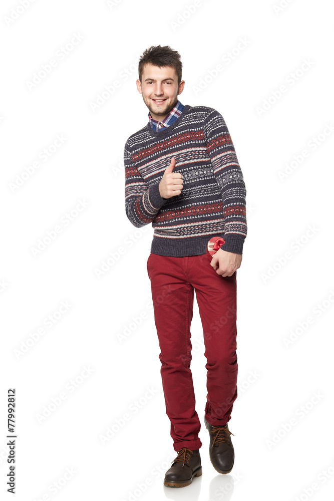Naklejka premium Young man with a heart-shaped gift isolated on white background.