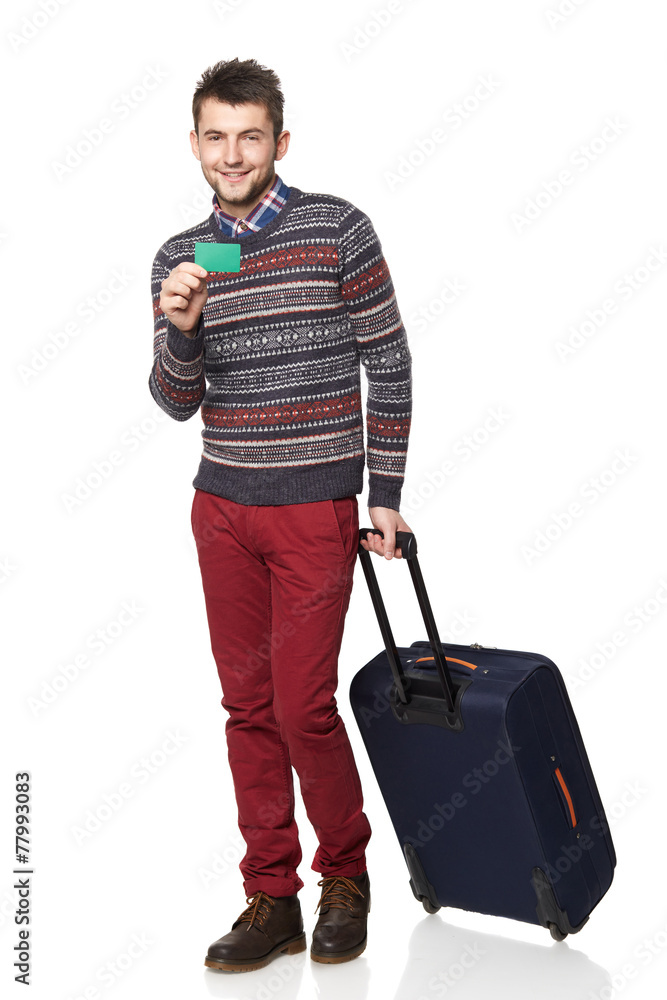 Men tourist. Young man standing with suitcase and holding a card Men tourist. Young man standing with suitcase and holding a card