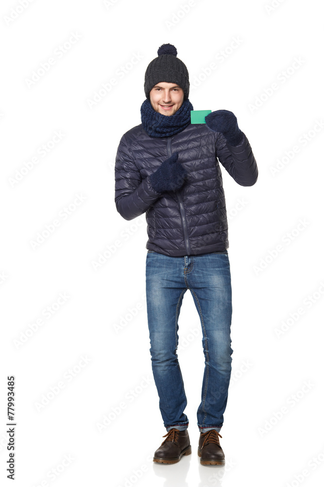 Christmas shopping. Smiling young man in winter hat and scarf sh Christmas shopping. Smiling young man in winter hat and scarf sh