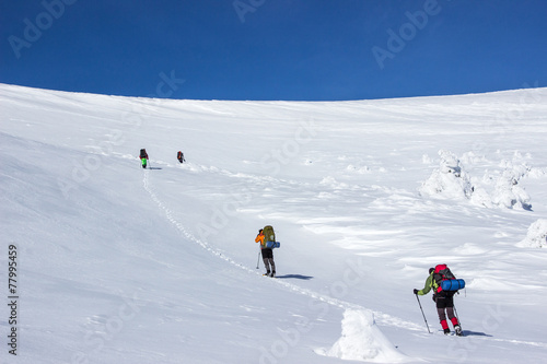 Winter hiking in the mountains on snowshoes .