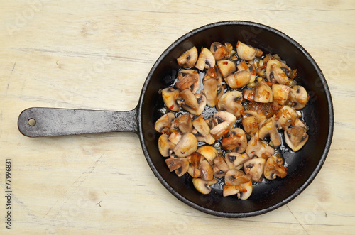 Delicious fried mushrooms in pan on table