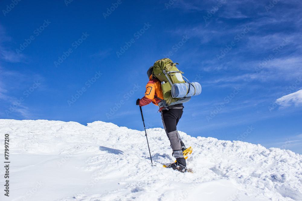 Winter hiking in the mountains on snowshoes . Winter hiking in the mountains on snowshoes .