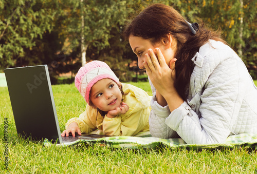 Mother and daughter working at the notebook