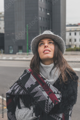 Beautiful young brunette posing in the city streets