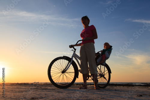 mother and baby biking at sunset © nadezhda1906