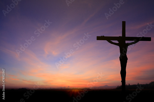 Dark Silhouette of Jesus with Cross over rainbow sunset concept for religion, worship, Christmas, Good Friday,  Easter, Jesus he is risen, Thanksgiving prayer and praise, promise