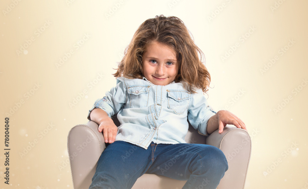 Blonde cute girl sitting on little armchair Blonde cute girl sitting on little armchair