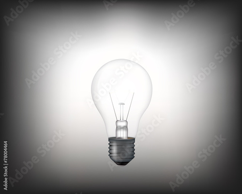 Realistic white light bulb shining in the dark.